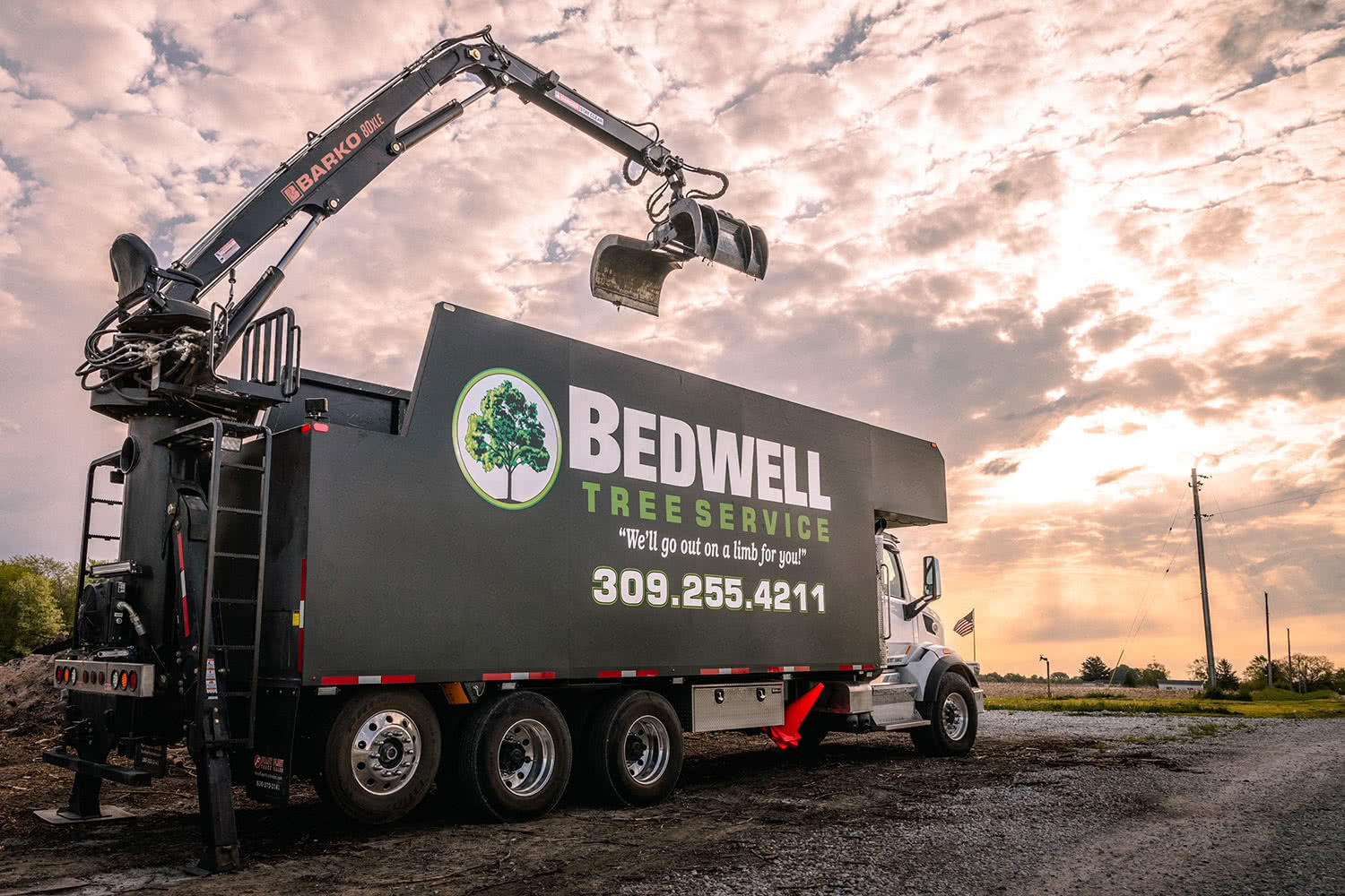 Bedwell Tree Service grapple truck at a tree work site